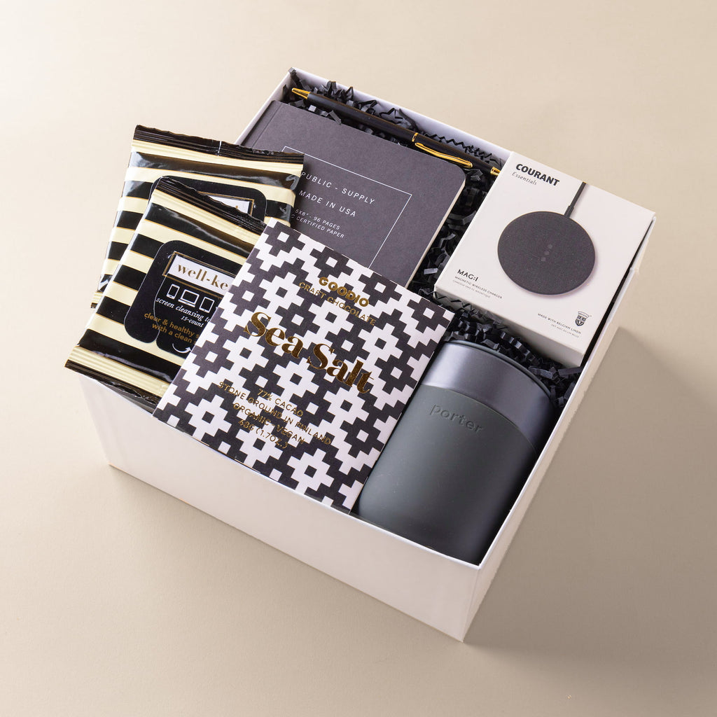 The Rare Workspace gift box is the perfect sophisticated-yet-practical gift for any modern executive, speaker, or ambitious project starter. This sleek set includes some essential desk accessories - craft chocolate, charger, travel mug, notebook, screen wipes and pen - to help take on any challenge. With products from Goodio, Courant, Public-Supply, Well-Kept and W&P.