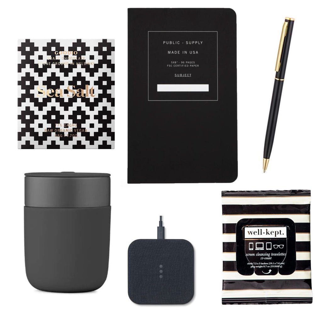Sea Salt chocolate bar by Goodio, 12 oz. Porter Mug by W&P, soft cover notebook by Public-Supply, Catch:1 charger by Courant, Buckead screen wipes by Well-Kept and a slim gold desk pen.